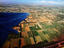 Aerial view of the south of the city and the wing of an aeroplane.