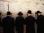 Men pray by the Western Wall (Wailing Wall).