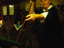 An owner of one of the wine cellars in Eger's 'Valley of the Beautiful Women' pours Egri Bikavar (Bull's Blood) from a flute into two glasses for patrons.