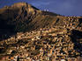 Overhead of adobe houses on city canyon wall.