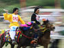 Tibetan Kampas racing horses around a track, a traditional sport.