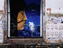 Mural, graffiti & posters on city wall.
