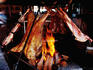Meat on barbeque in restaurant window.