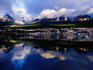 City & mountains reflected in harbour.
