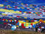 Pilgrim stringing prayer flags, Tibet