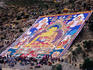 Pilgrims attending annual celebration of hanging of huge thangka, Drepung Monastery.