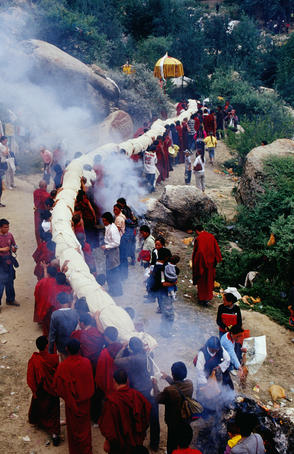 Monks carrying rolled up thangka, Drepung Monastery.