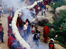 Monks carrying rolled up thangka, Drepung Monastery.