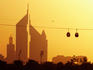 Creekside Park cable cars (gondolas) passing the Emirates Towers at sunset.