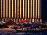 Crowded ferries (abras) crossing Dubai Creek beneath a looming Deira skyscraper.