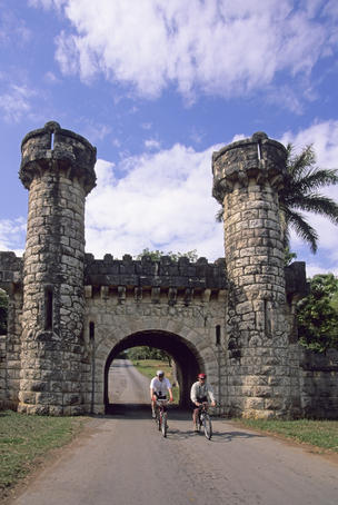 Bicyclists at entrance of Hacienda Cortina.
