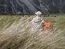 Man resting on walking track in Hooker Valley.