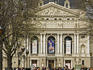 People walk down Prospekt Svobody towards Ivan Franko Opera and Ballet Theatre.