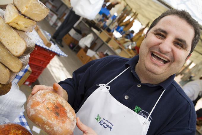 Man Selling Cheese at Market.