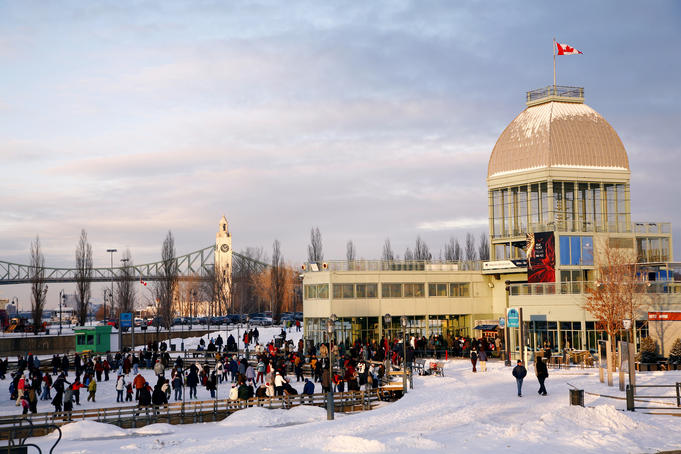 Domed building with Canadian flag flying, Parc du Bassin Bonsecours, with Sailor's Memorial Clocktower in background.