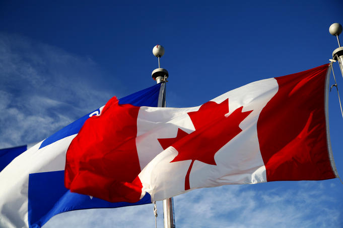 Canadian and Quebec flags flying side-by-side.