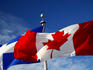 Canadian and Quebec flags flying side-by-side.