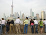 People looking across Huangpu river towards Pudong from the Bund.