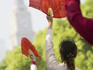 Women practising tai chi with fans on the Bund.