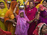Group of females going to wedding in colorful saris.