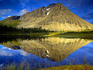 Mount Storetinden mirrors itself in a small lake, Lyngsalpene.