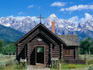 The Chapel of the Transfiguration, built in the traditional log-cabin style, and the Teton Range - Grand Teton National Park, Wyoming