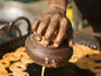 Man frying Jalebis batter to make sweets at roadside stall.