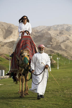 woman riding camel