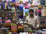 Vendor selling colorful clothing and fabrics in Al Naif souq in Deira.