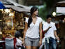 Young Pan-Asian woman walking around shops.