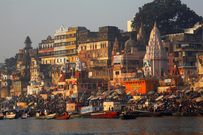 India Varanasi main ghat steps down to river Ganges with iconic pilgrims and bathers at river Ganges Jan 2007