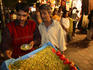 Snack seller with customer at night market, Janpath.