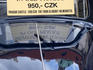 Sightseeing tour sign on windscreen of old car.