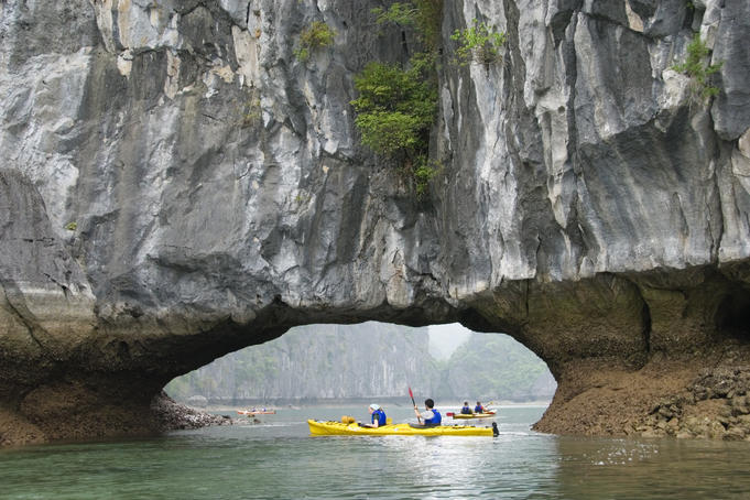 Sea kayaking amongst limestone karst towers and arches.