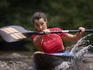 Female white-water kayaker training.