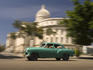 Classic American car passing Capitolio, Old Havana.
