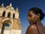 Cuban young woman in front of Ermita de Nuestra Senora de la Candelaria de la Popa.