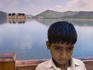 Indian boy in front of Jal Mahal (Water Palace) on Man Sagar lake.