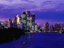 City skyline along Brisbane River at dusk.