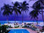 Resort swimming pool & palm trees at dusk at Dover Beach.