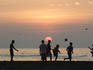 Boys playing beach soccer at sunset, Michoacan