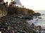 Coastal rocks and waterfront shadecloth along the Malecon.