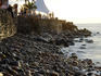 Coastal rocks and waterfront shadecloth along the Malecon.