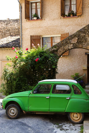 Old green Renault near house.