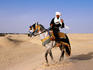 Traditionally dressed Berber man on horse near the Zone touristique.