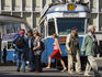 People and tram on affluent Paradeplatz.