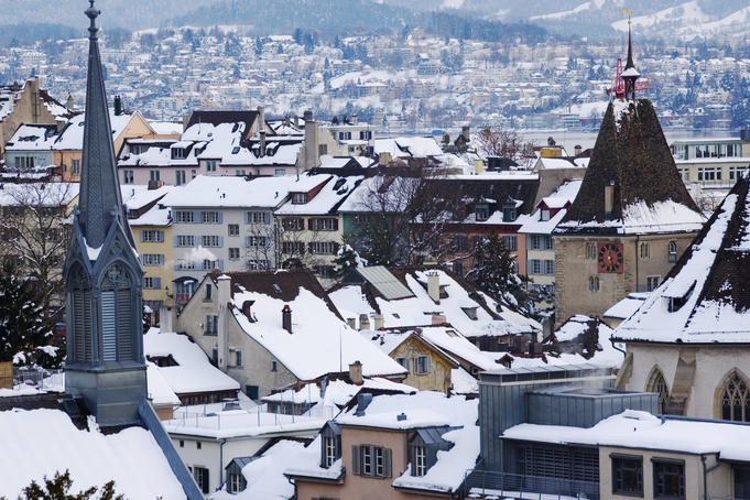 Overhead of snow-covered roofs with the Grimmenturm (medival residential tower), Neumarkt.