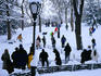 People ride sleds in snowy Central Park.