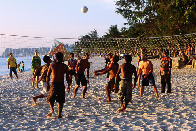 Volleyball game at sunset, White Beach.