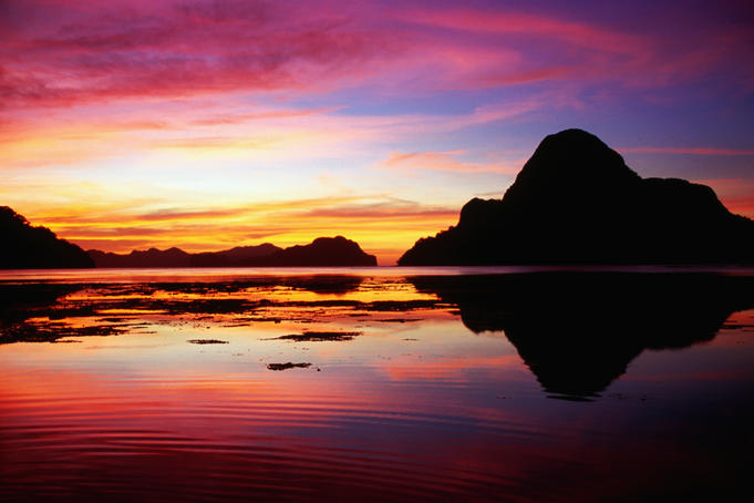 Cadlao Island silhouetted at sunset.